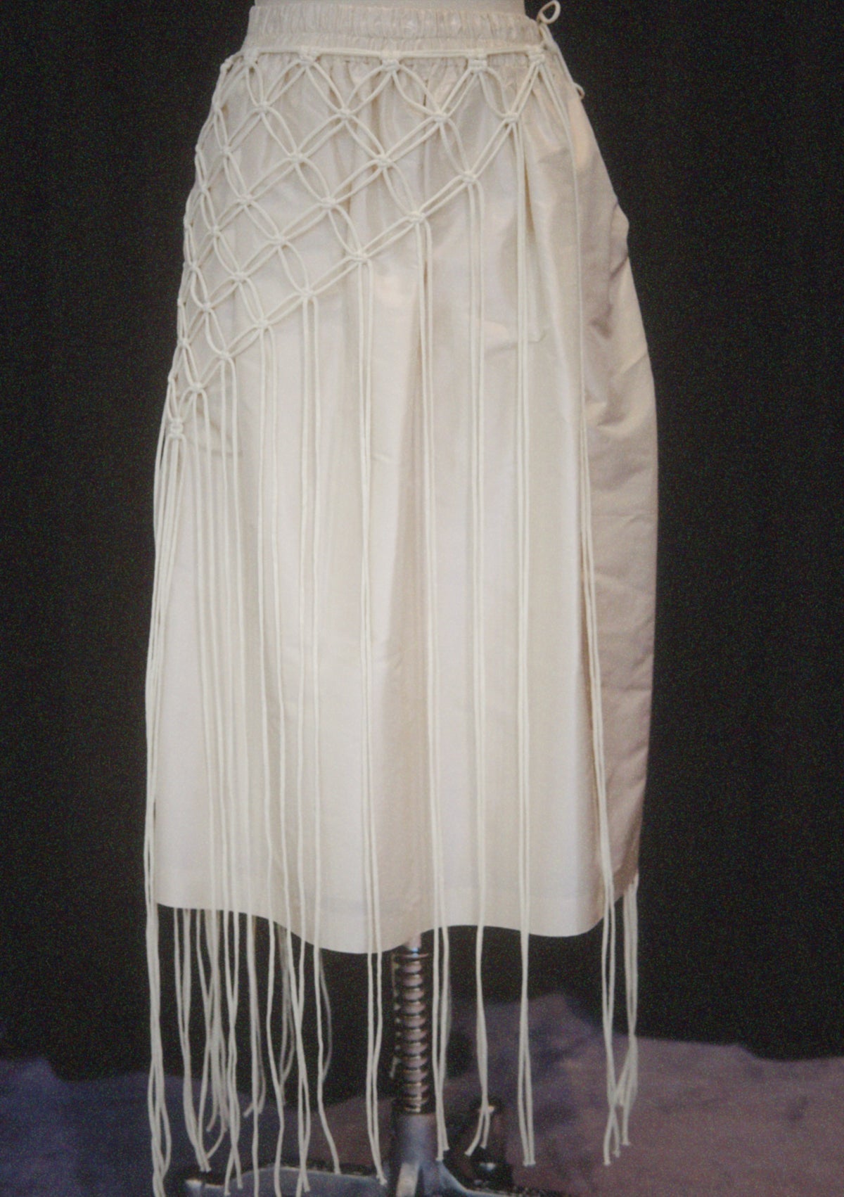 A minimalist cape handcrafted from braided cotton cord