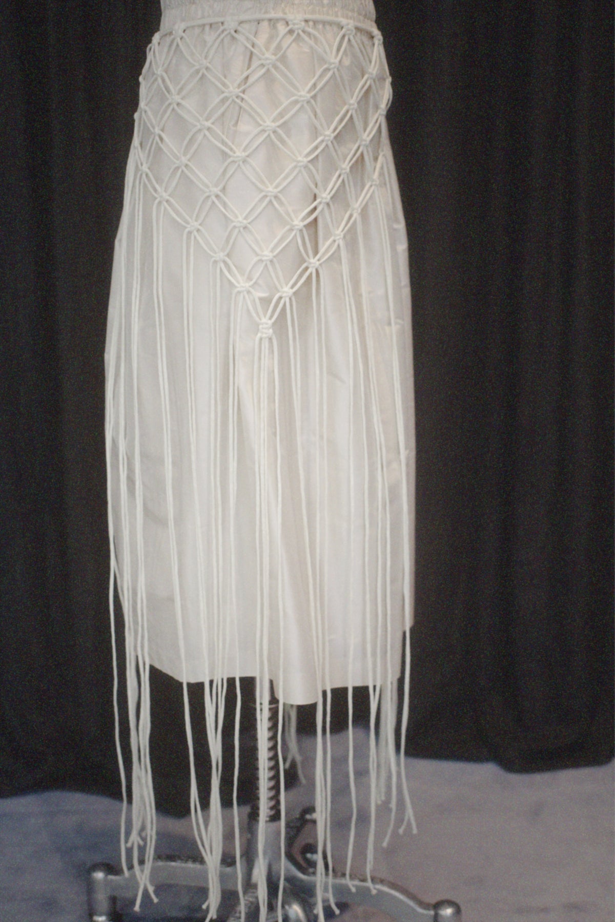 A minimalist cape handcrafted from braided cotton cord