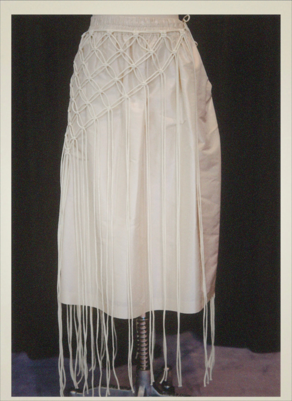 A minimalist cape handcrafted from braided cotton cord