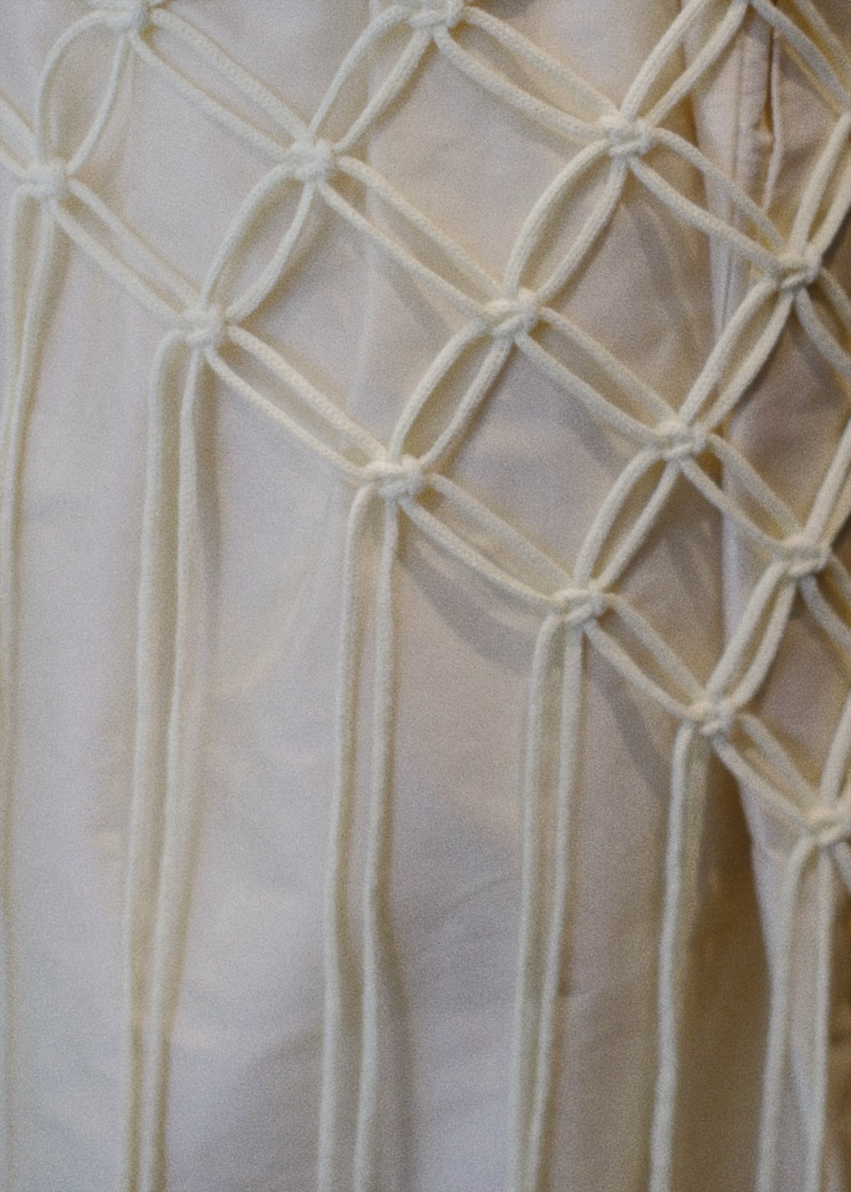 A minimalist cape handcrafted from braided cotton cord